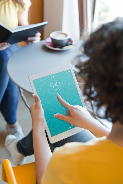 Woman with tablet in library