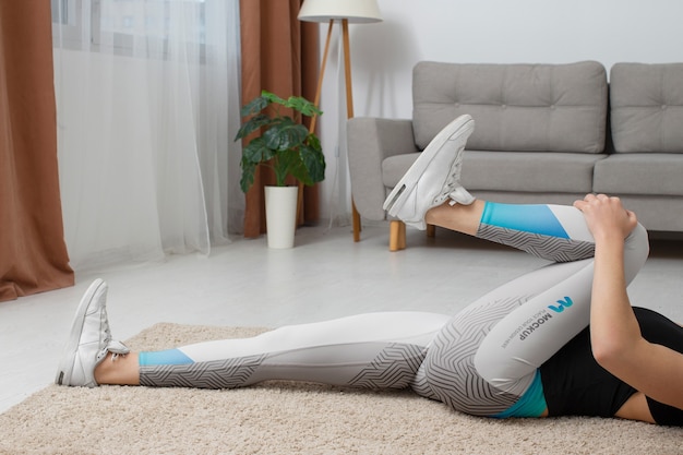 PSD woman working out indoors while wearing leggings