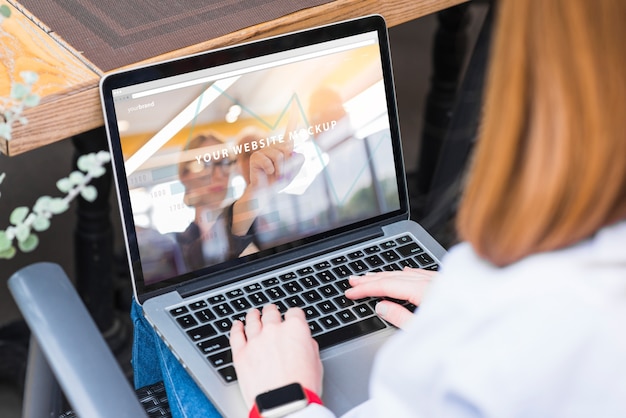 Woman working with laptop mockup