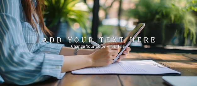 PSD women hand writing paper on wooden table and hand holding phone