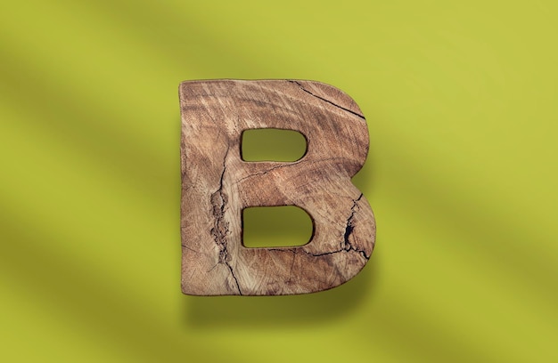 A wooden letter b on a green background PSD