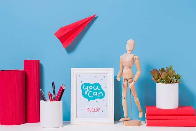 Wooden mannequin and school supplies with mock-up