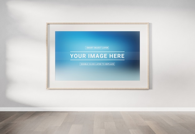 PSD wooden photo frame mockup hanging on a white wall