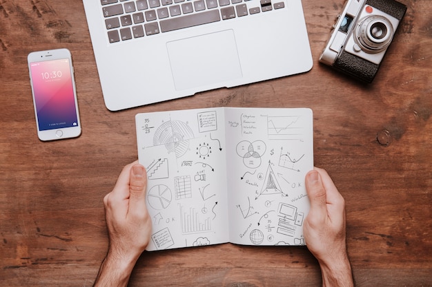 Workspace concept with hands holding brochure