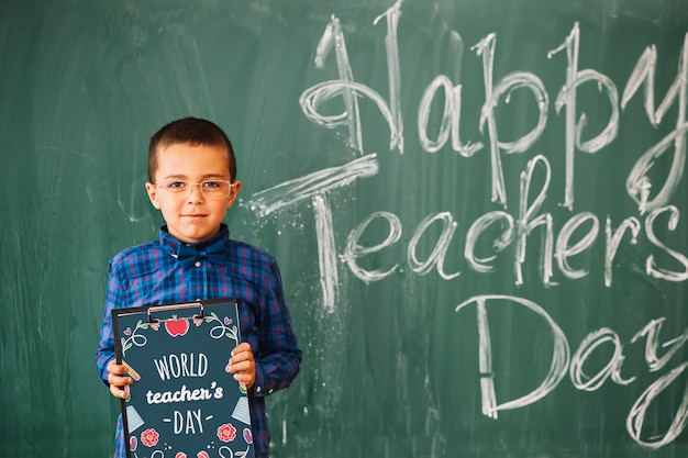 World teacher day mockup with kid holding clipboard