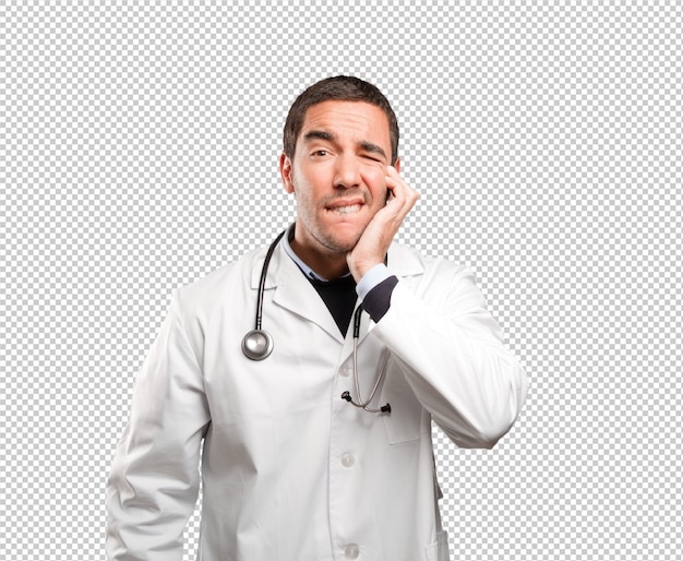 Worried doctor with toothache against white background