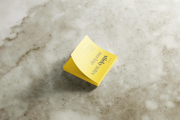 PSD a yellow box with the word  on it is laying on a white marble surface