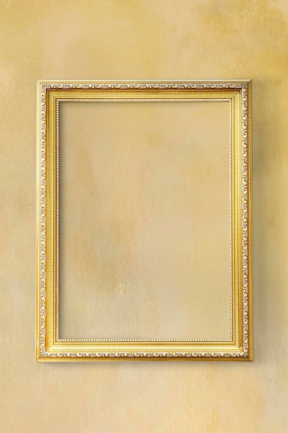 Yellow classic photo frame on a yellow wall