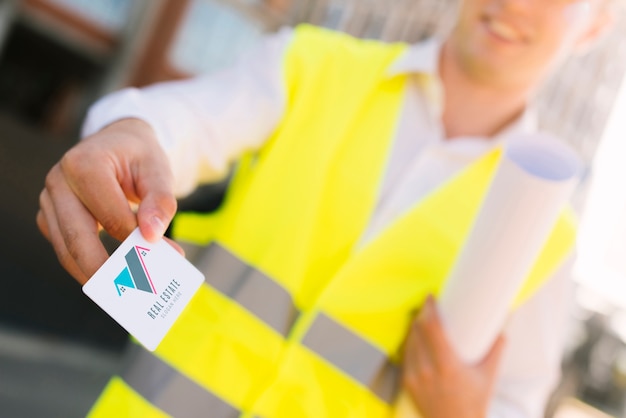 Young architect holding a business card mock-up