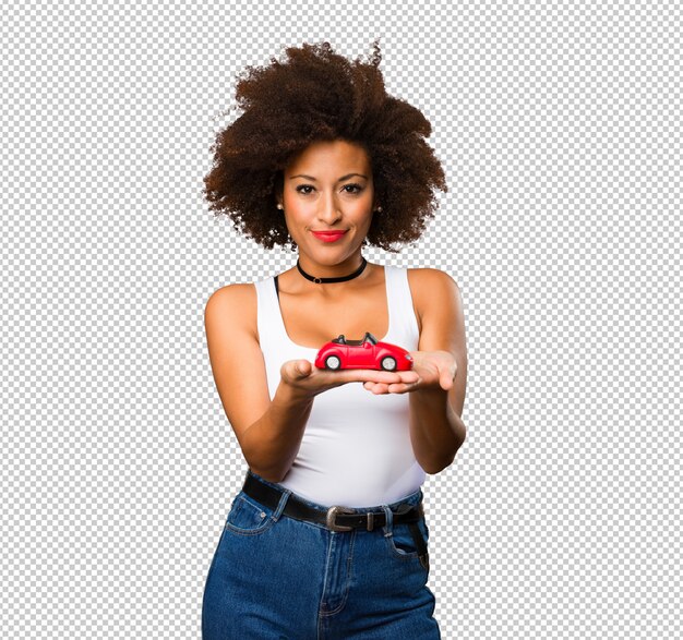 Young black woman holding a red car