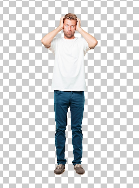 PSD young blonde man shouting with a crazy, amazed look of surprise, holding head with both hands.