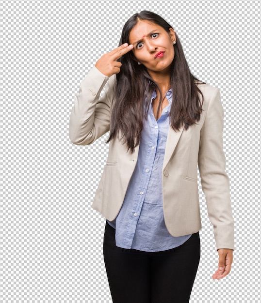 Young business indian woman making a suicide gesture, feeling sad and scared forming a gun with fingers