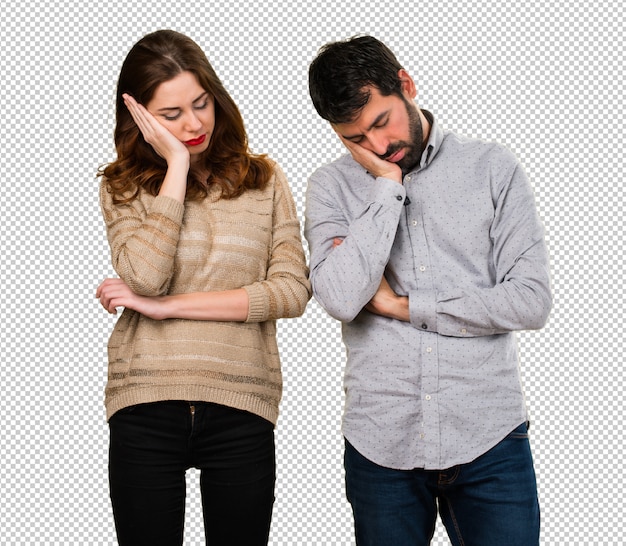 Young couple making sleep gesture