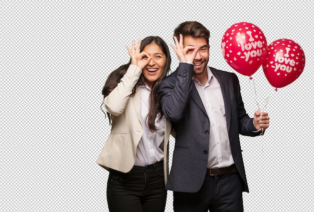 Young couple in valentines day confident doing ok gesture on eye