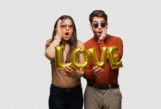 Young couple in valentines day surprised and shocked