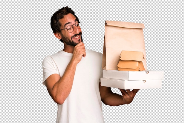 Young crazy bearded and expressive man taking take away fast food empty blank packagings