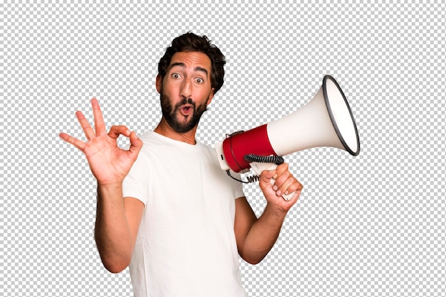 Young crazy bearded and expressive man using a megaphone to say a message