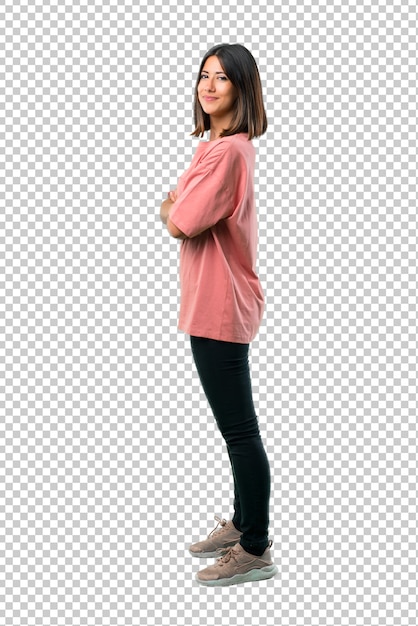 Young girl with pink shirt keeping the arms crossed in lateral position while smiling