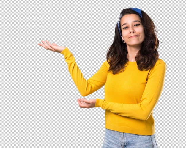 Young girl with yellow sweater and blue bandana on her head extending hands