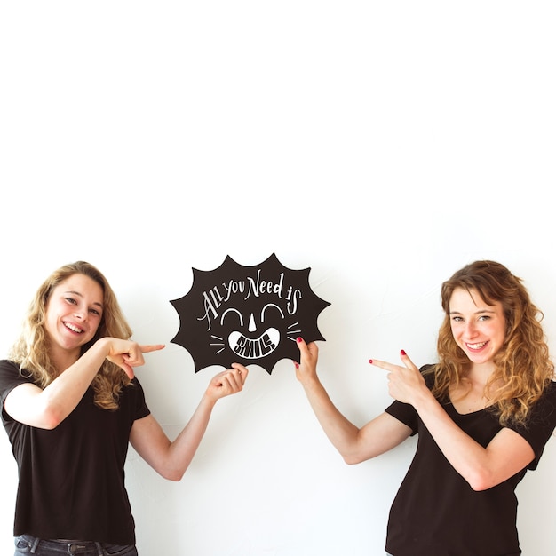 Young girls holding speech bubble slate mockup