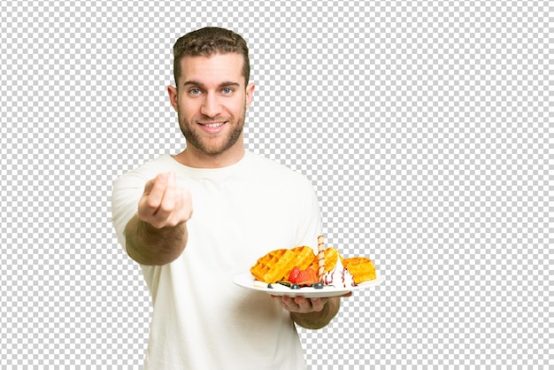 Young handsome blonde man holding waffles over isolated chroma key background making money gesture