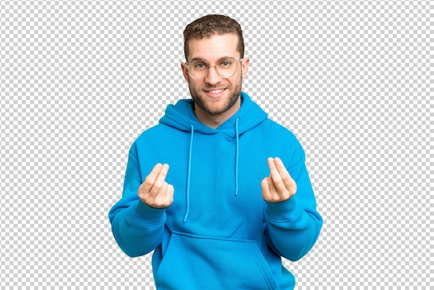 Young handsome blonde man over isolated chroma key background making money gesture