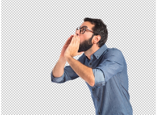 Young hipster man shouting over white background