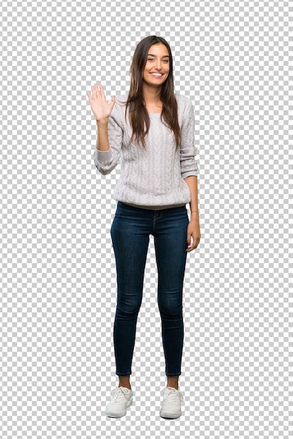 Young hispanic brunette woman saluting with hand with happy expression