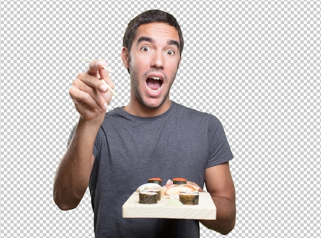 Young man eating sushi