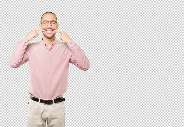 Young man pointing to his teeth