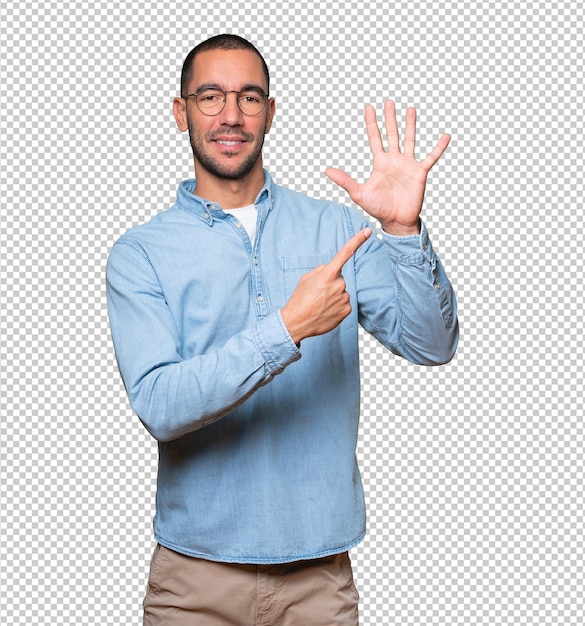 Young man pointing to his wrist