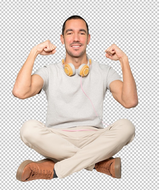 PSD young man in sitting position with a celebration gesture