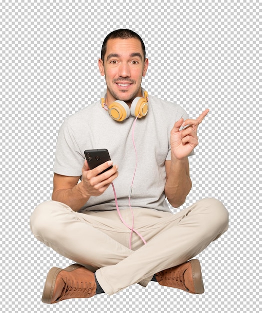 Young man in sitting position with a finger pointing gesture