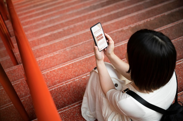 Young person using phone mockup