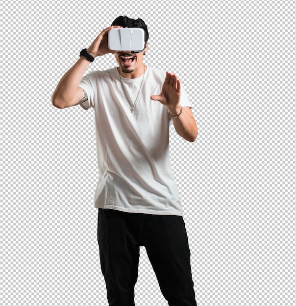 Young rapper man excited and entertained, playing with virtual reality glasses, exploring a fantasy world, trying to touch something