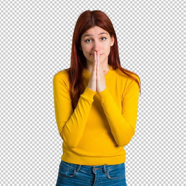 PSD young redhead girl with yellow sweater keeps palm together. person asks for something