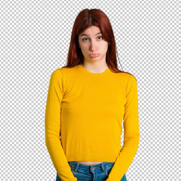 PSD young redhead girl with yellow sweater with sad and depressed expression. serious gesture