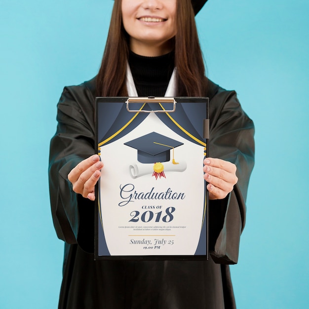 Young student holding diploma with mock-up