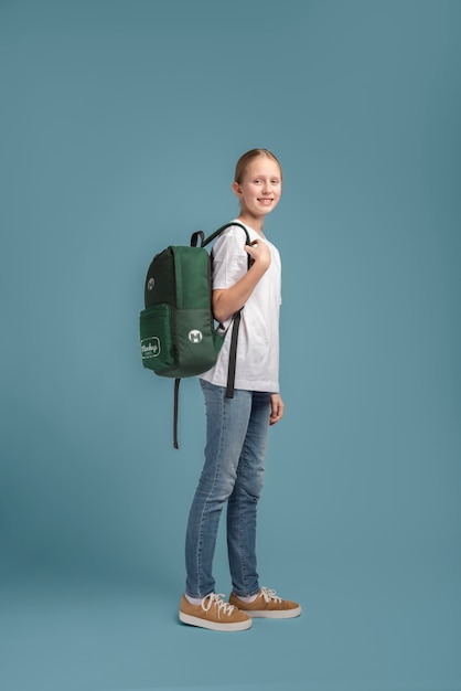 Young teenage girl carrying a backpack mock-up