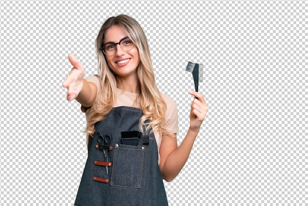 PSD young uruguayan hairdresser woman over isolated background shaking hands for closing a good deal