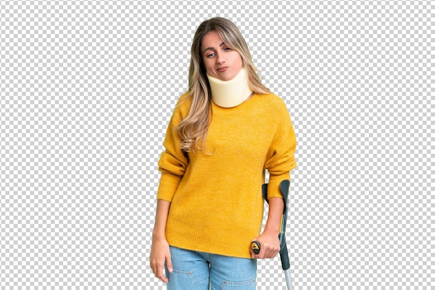 Young Uruguayan woman wearing neck brace and crutches over isolated background with sad expression