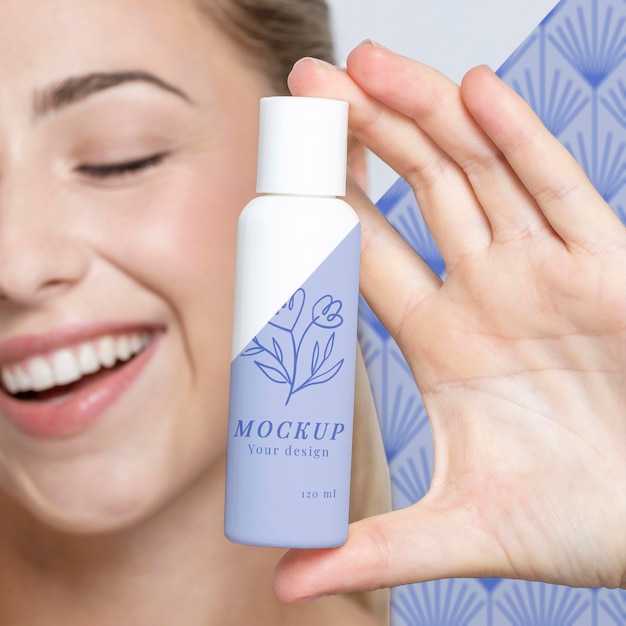 Young woman holding a skincare product mock-up