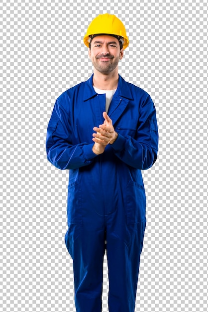 Young workman with helmet applauding after presentation in a conference