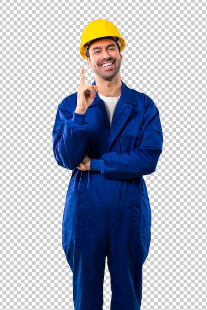 Young workman with helmet showing and lifting a finger in sign of the best