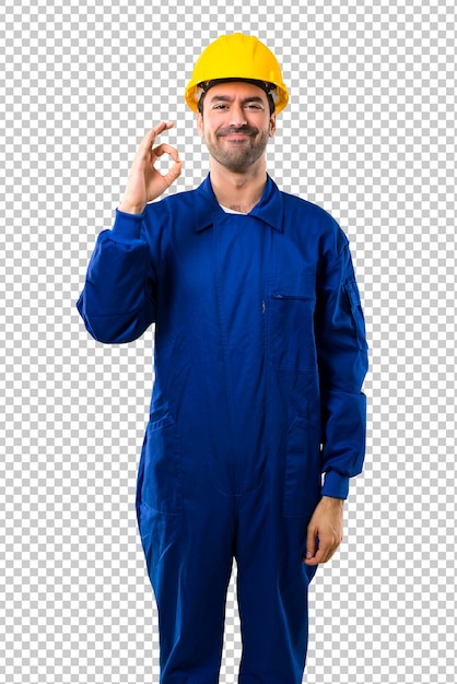 Young workman with helmet showing an ok sign with fingers. Face of happiness and satisfaction