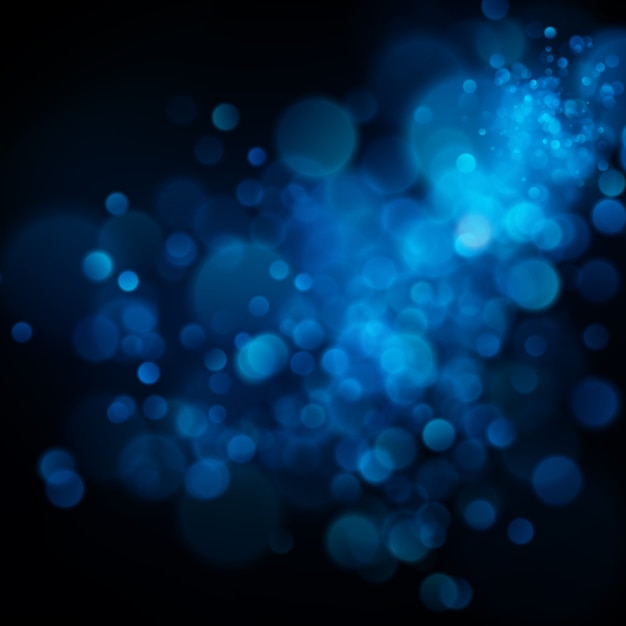 Abstract defocused circular blue bokeh on dark background. 