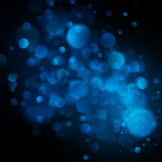 Abstract defocused circular blue bokeh on dark background. 