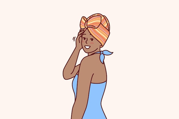 African American woman with traditional turban on head is dressed in blue dress for ethnic party