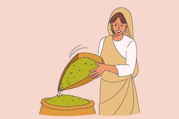 Arabic woman winnowing grains in field