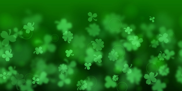 Background on St Patrick's Day made of blurry clover leaves in green colors with seamless horizontal repetition